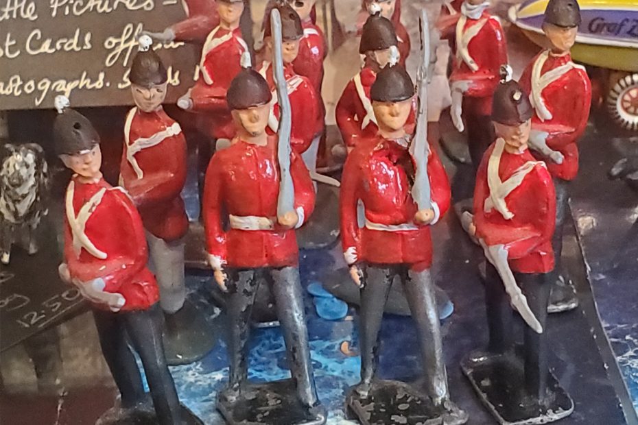 A photograph of vintage toy soldiers in red uniforms