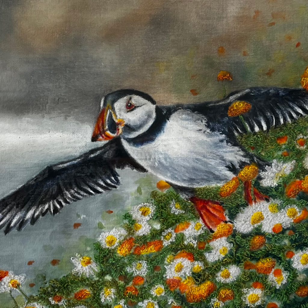 Puffin artwork with orange and white flowers